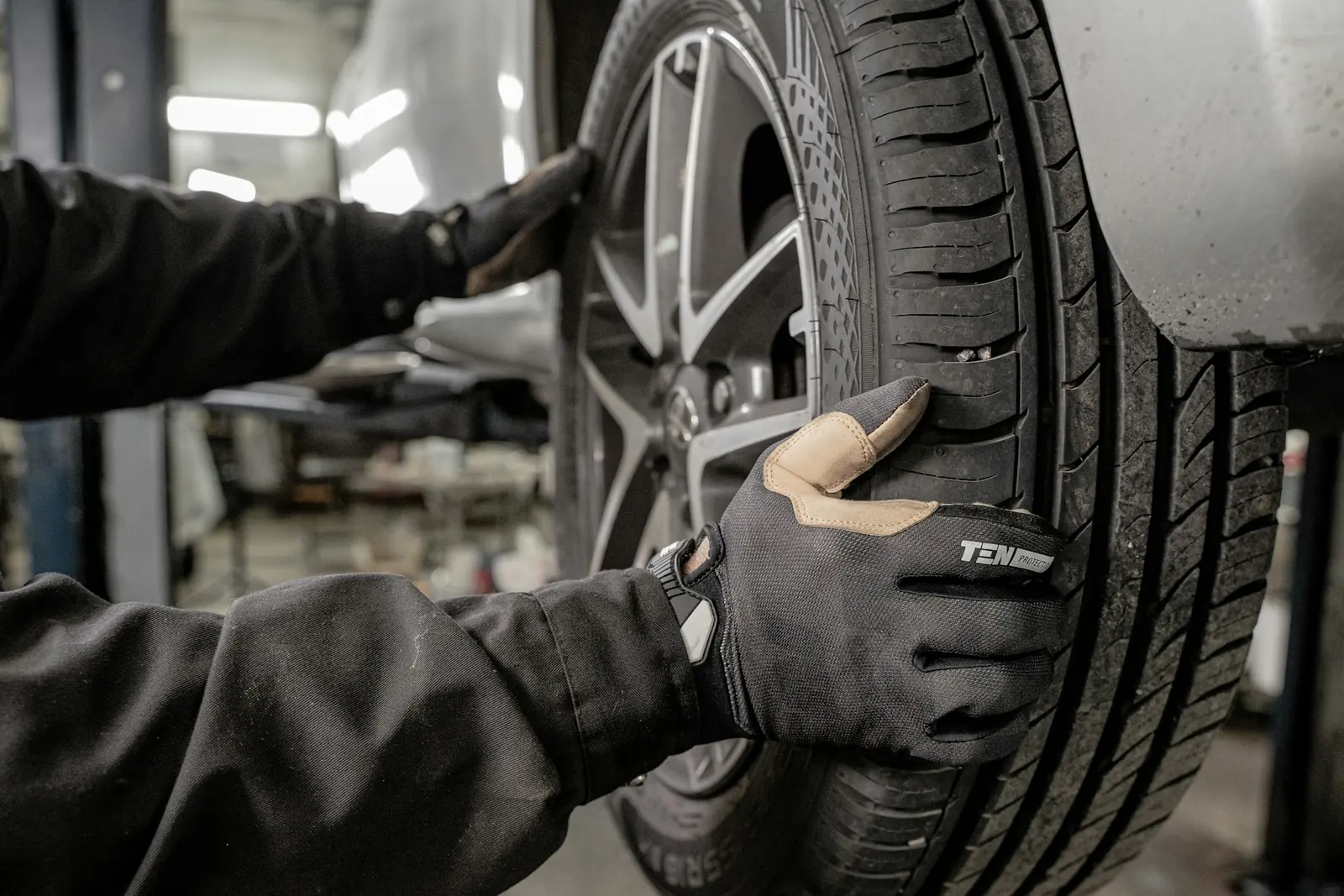 Mechanic in gloves working on a tire