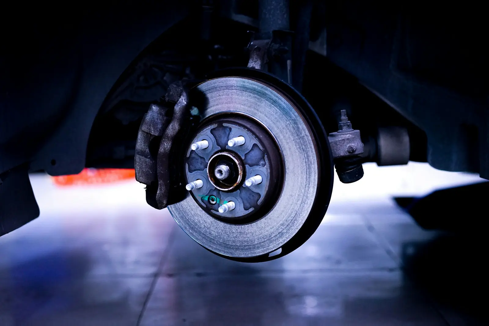 Brake rotor and caliper close-up during mechanic work
